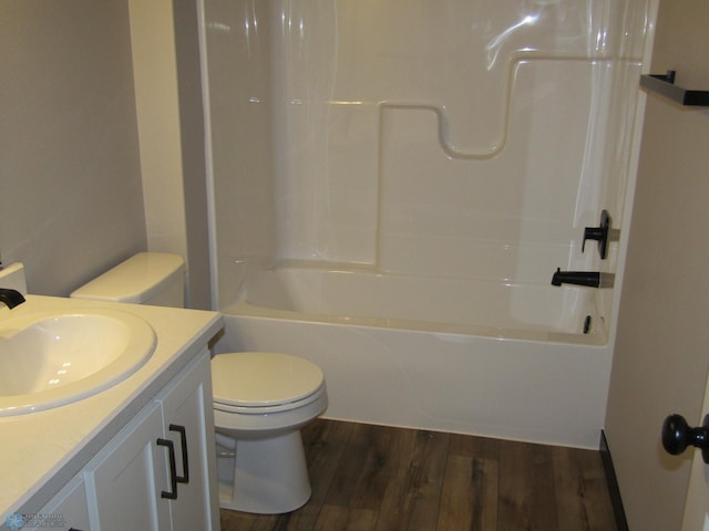 full bathroom with washtub / shower combination, hardwood / wood-style floors, vanity, and toilet