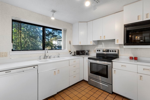 kitchen featuring white dishwasher, black microwave, sink, white cabinetry, and stainless steel electric range oven