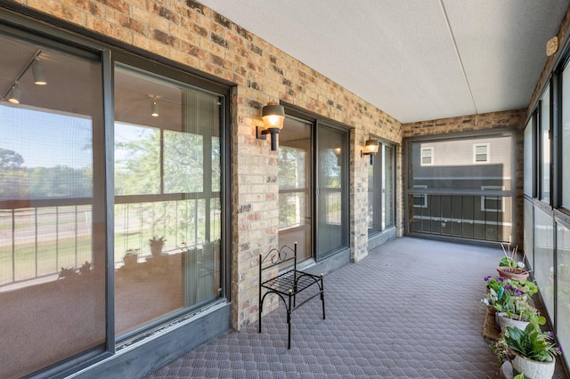 unfurnished sunroom featuring a wealth of natural light