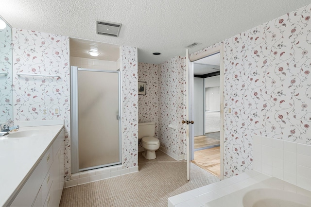 full bathroom featuring tile patterned floors, vanity, a textured ceiling, shower with separate bathtub, and toilet