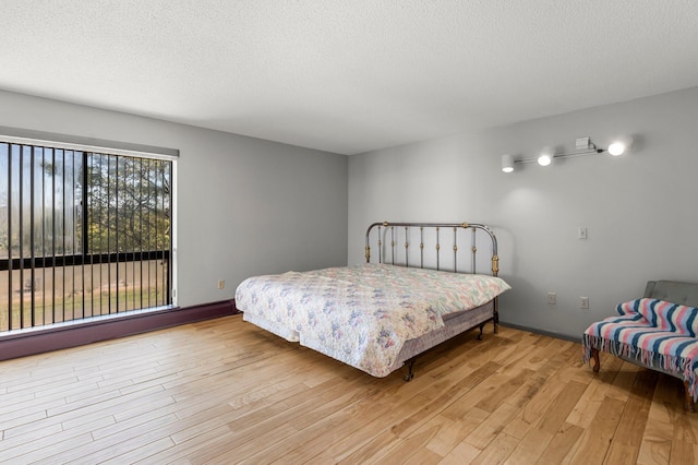 bedroom featuring a textured ceiling and light wood-type flooring