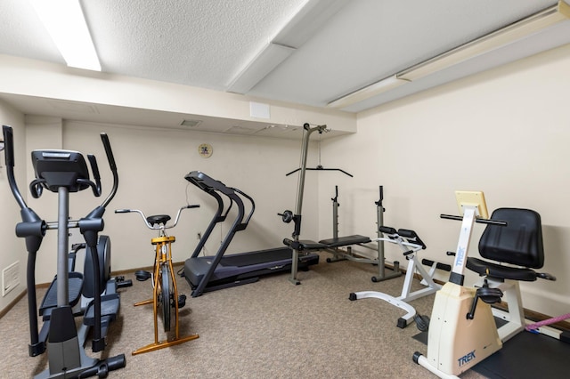 exercise room featuring a textured ceiling