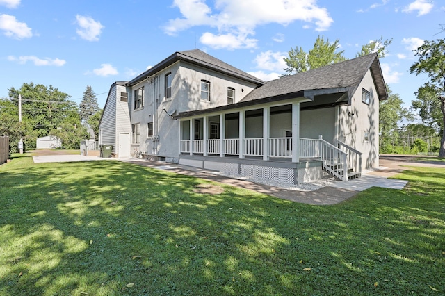 back of house with a porch and a yard