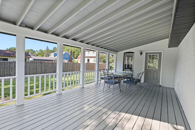 wooden terrace with a lawn