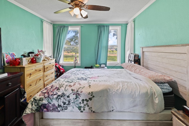 bedroom featuring ceiling fan, a textured ceiling, and ornamental molding