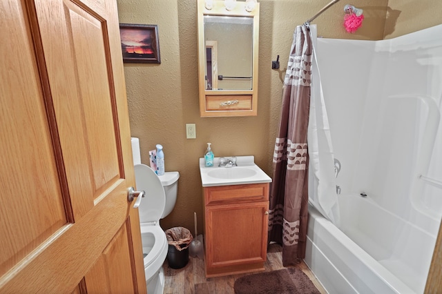 full bathroom featuring toilet, vanity, hardwood / wood-style flooring, and shower / tub combo with curtain