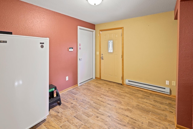 foyer featuring light hardwood / wood-style flooring and a baseboard radiator