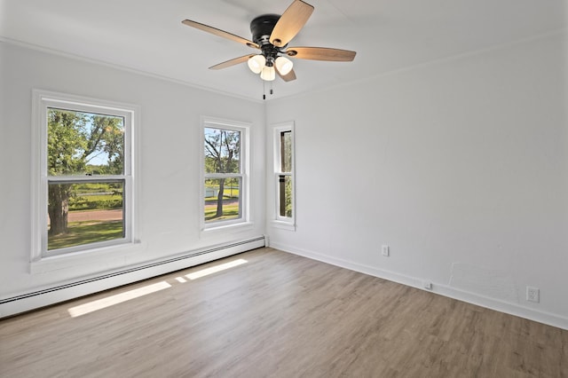 empty room featuring baseboard heating, ceiling fan, hardwood / wood-style floors, and crown molding