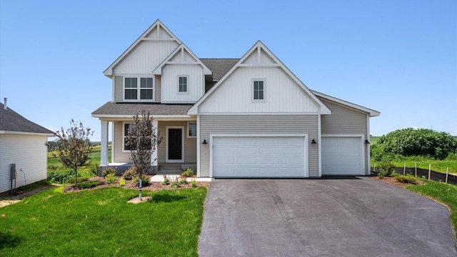 view of front of property featuring a front yard and a garage