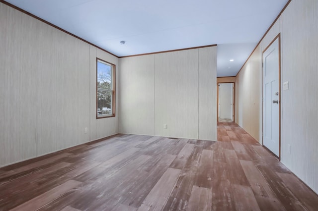 spare room with light hardwood / wood-style flooring and ornamental molding