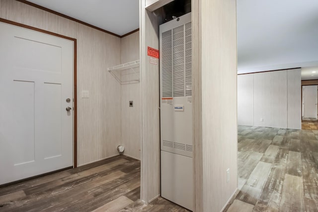 laundry area with hardwood / wood-style floors, electric dryer hookup, and ornamental molding