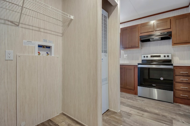 kitchen featuring ornamental molding, light hardwood / wood-style floors, and stainless steel range with electric cooktop