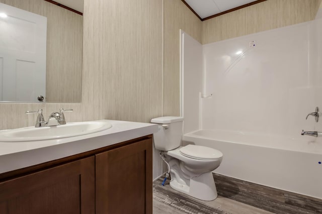 full bathroom with hardwood / wood-style floors, vanity, toilet, and shower / bathing tub combination