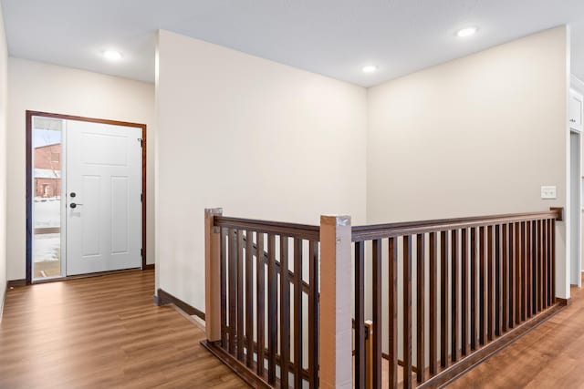 corridor with hardwood / wood-style floors