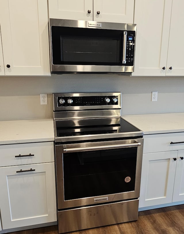 kitchen with stainless steel appliances and white cabinetry