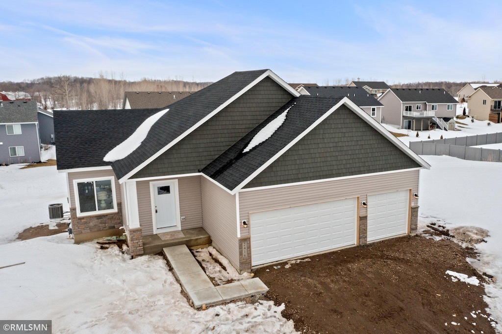 view of front of house featuring cooling unit and a garage