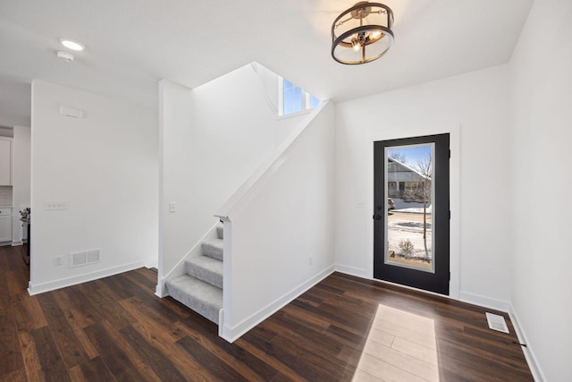 entryway with dark hardwood / wood-style flooring