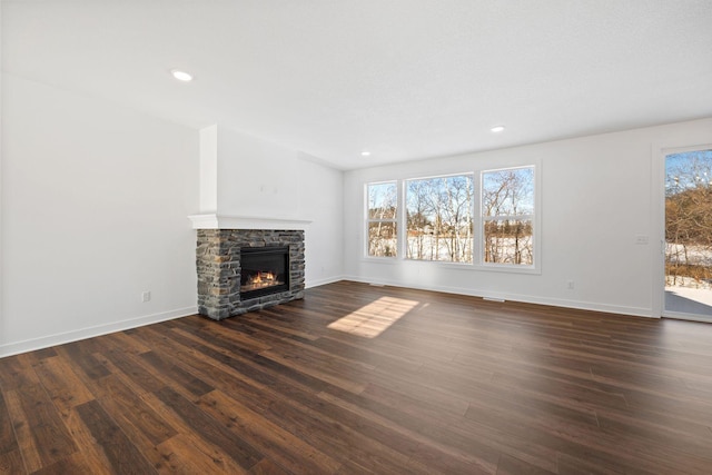 unfurnished living room with a fireplace and dark hardwood / wood-style floors