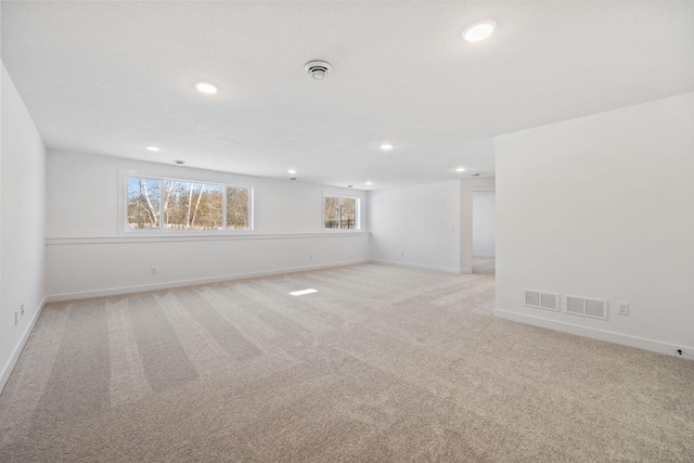 empty room featuring light carpet and plenty of natural light