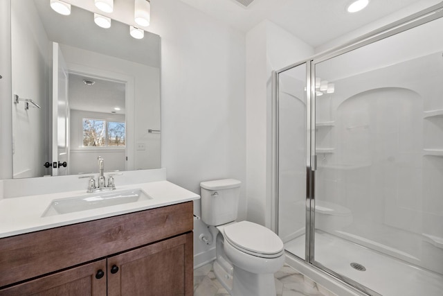 bathroom featuring toilet, walk in shower, and vanity