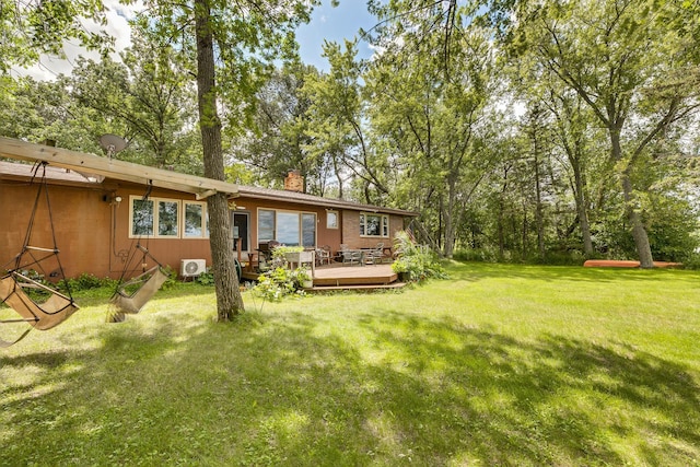 view of yard with ac unit and a deck