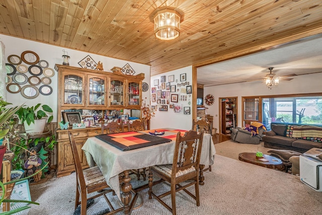 carpeted dining space with ceiling fan with notable chandelier and wood ceiling