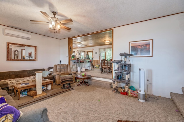 living room with a wall unit AC, ceiling fan, carpet floors, and a textured ceiling