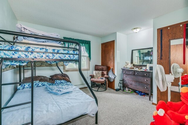 bedroom with carpet floors and a baseboard radiator