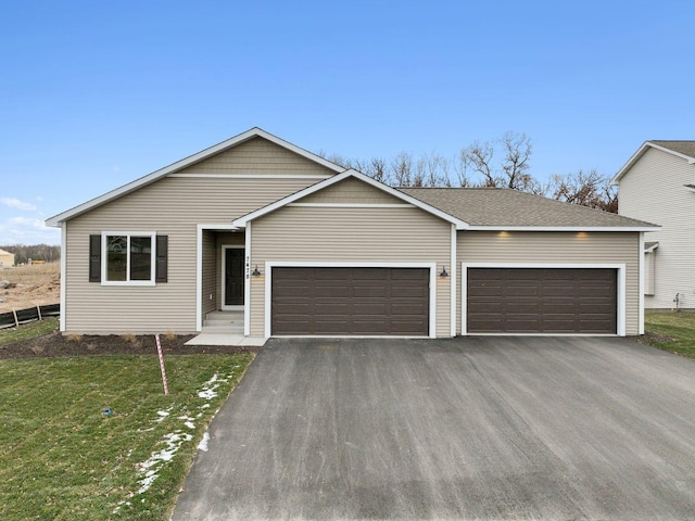 view of front of home featuring a garage and a front lawn