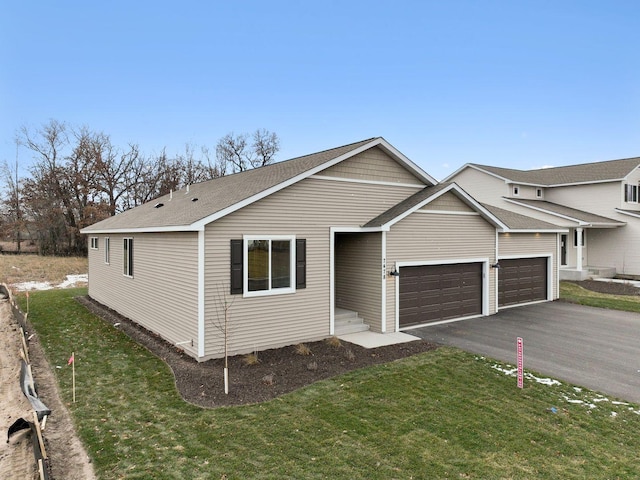 view of front of property with a garage and a front yard