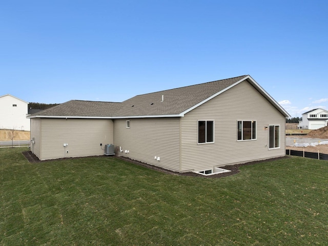 back of house featuring a lawn and central AC