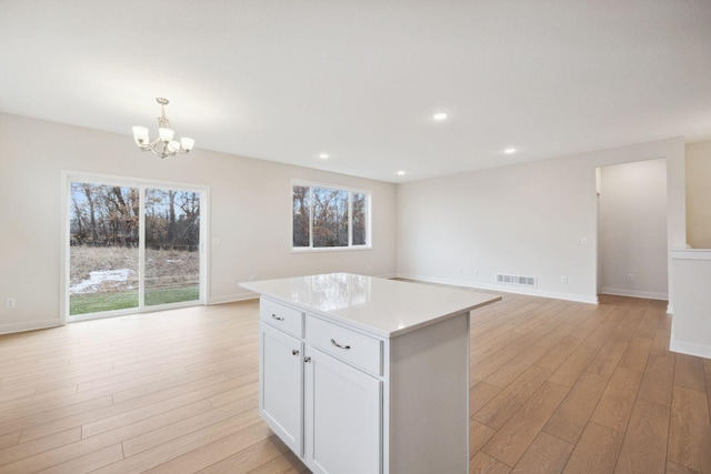 kitchen featuring pendant lighting, a healthy amount of sunlight, and light wood-type flooring