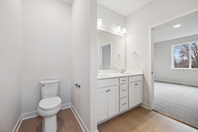 bathroom featuring vanity, toilet, and wood-type flooring