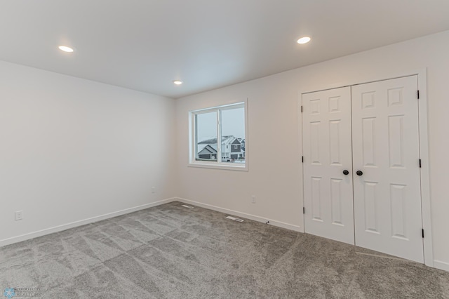 unfurnished room featuring light carpet