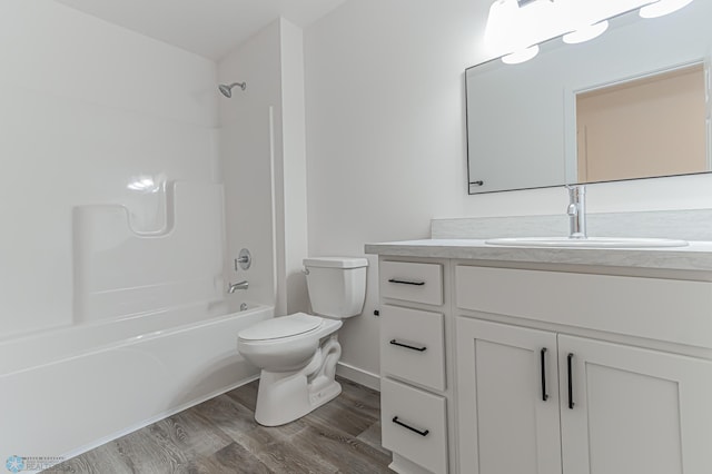 full bathroom featuring toilet,  shower combination, hardwood / wood-style floors, and vanity