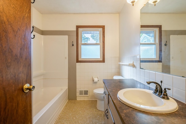 full bathroom featuring tile patterned floors, vanity, a healthy amount of sunlight, and toilet