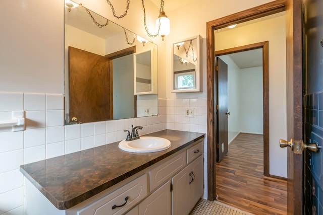 bathroom with tasteful backsplash, hardwood / wood-style floors, and vanity