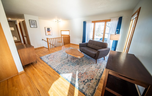 living room with baseboards and wood finished floors