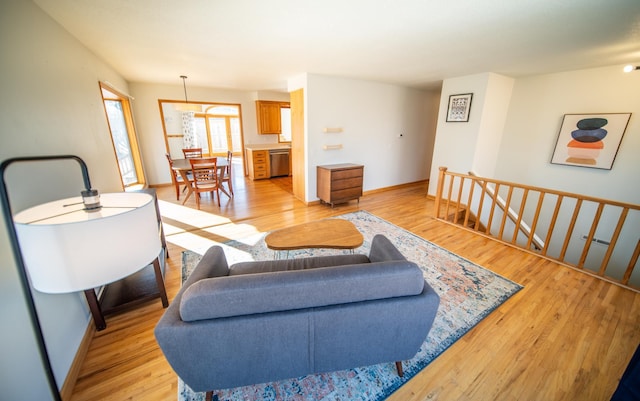 living room featuring baseboards and light wood finished floors