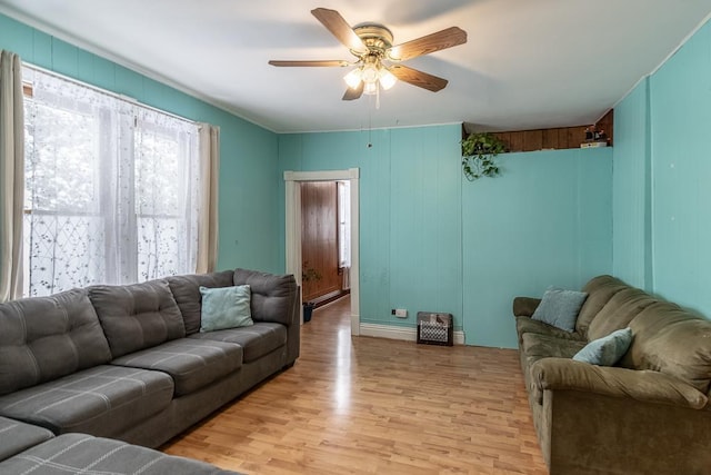 living room featuring ceiling fan and light hardwood / wood-style floors