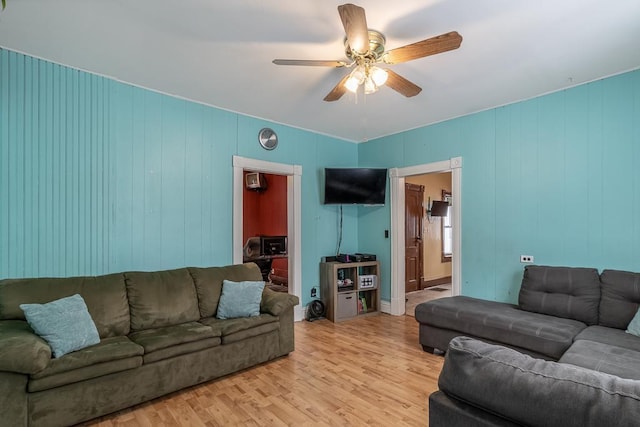 living room with ceiling fan and light hardwood / wood-style flooring