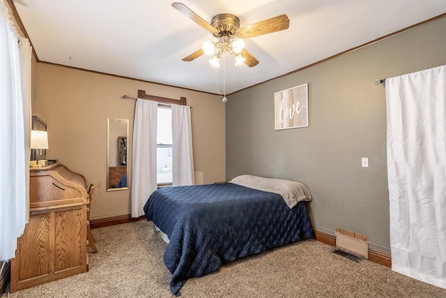 bedroom featuring ceiling fan, light colored carpet, and ornamental molding