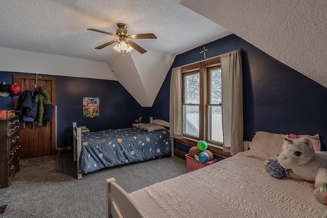 bedroom featuring a textured ceiling, carpet floors, ceiling fan, and lofted ceiling