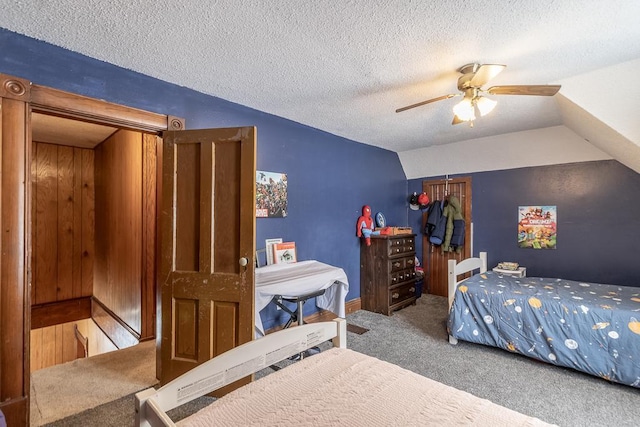 bedroom featuring carpet flooring, ceiling fan, a textured ceiling, and lofted ceiling