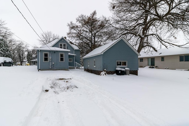 view of snow covered back of property