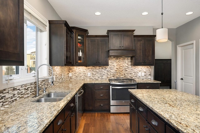 kitchen with dark hardwood / wood-style floors, pendant lighting, sink, stainless steel appliances, and dark brown cabinets