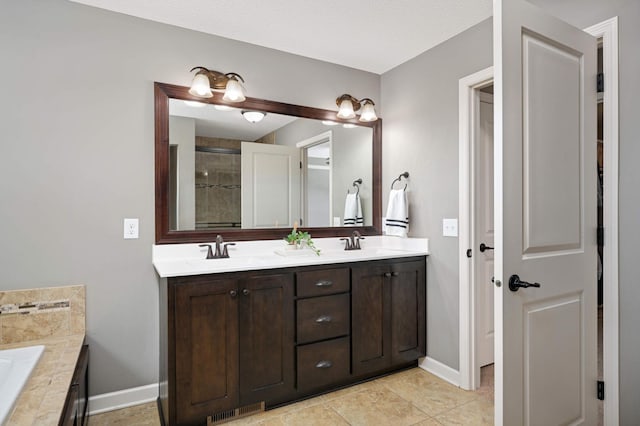 bathroom with vanity and tiled bath