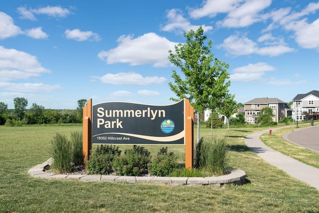 community / neighborhood sign with a lawn