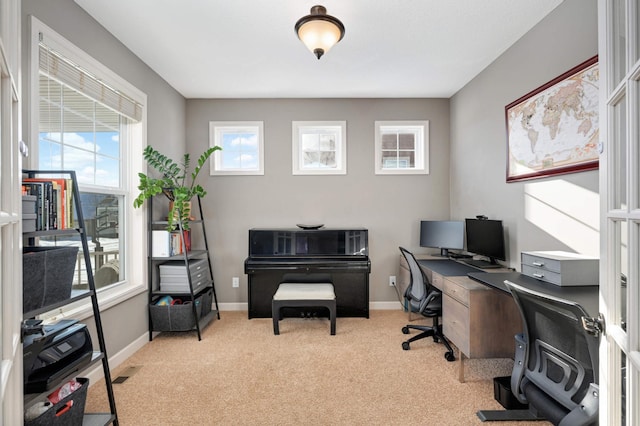 carpeted home office featuring visible vents and baseboards