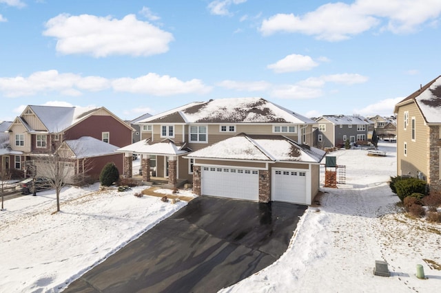 view of front of property featuring a garage, driveway, and a residential view